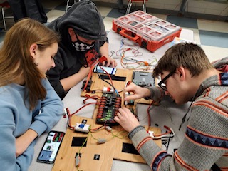 Electrical Team members Lauren Rollette, Arson Webster, and Calvin Baker work on a prototype board