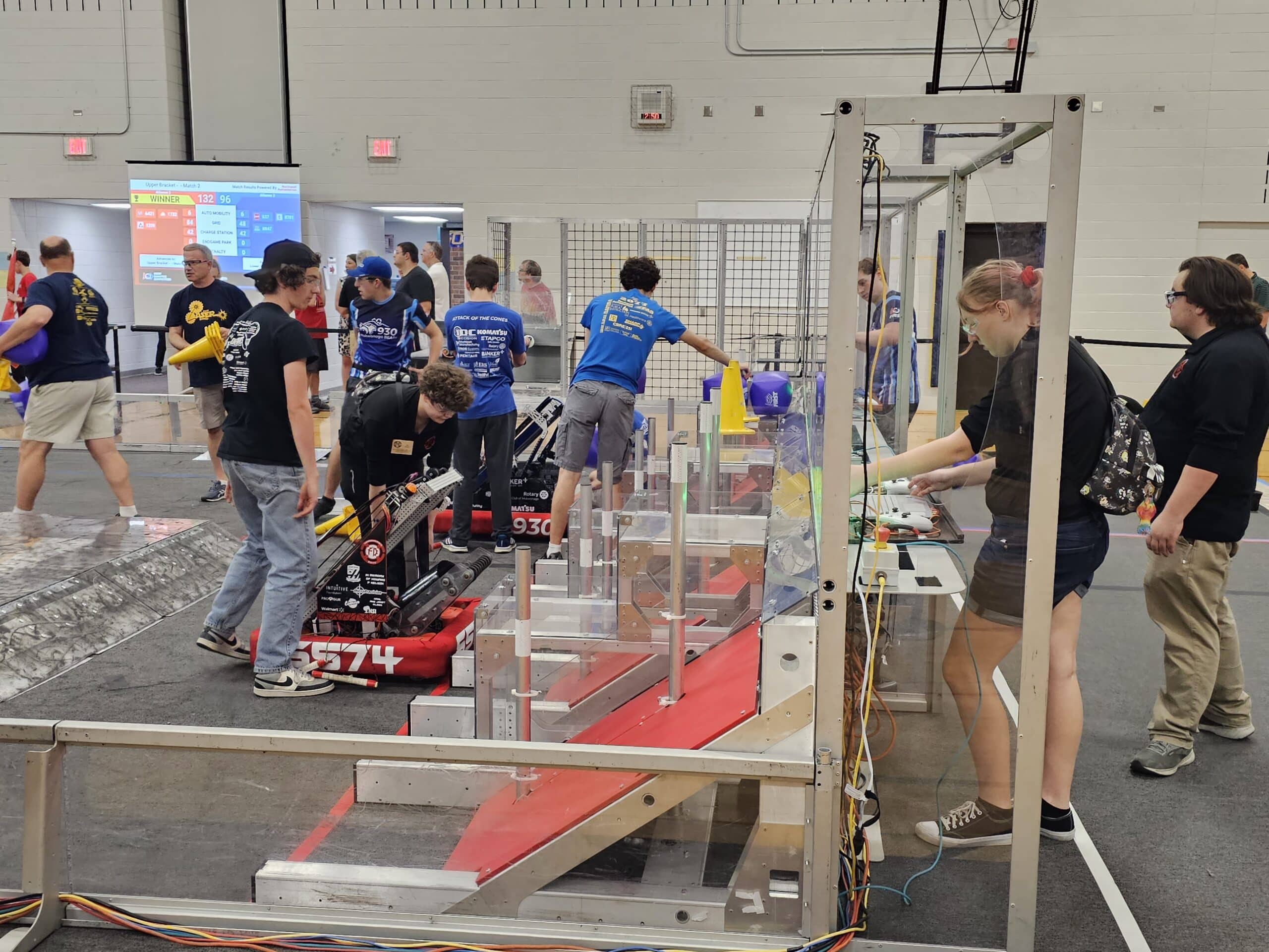 Drive Team Members Andrew O'Toole, Ace Hudec, and Erison Dreksler set up the robot for a qualification match