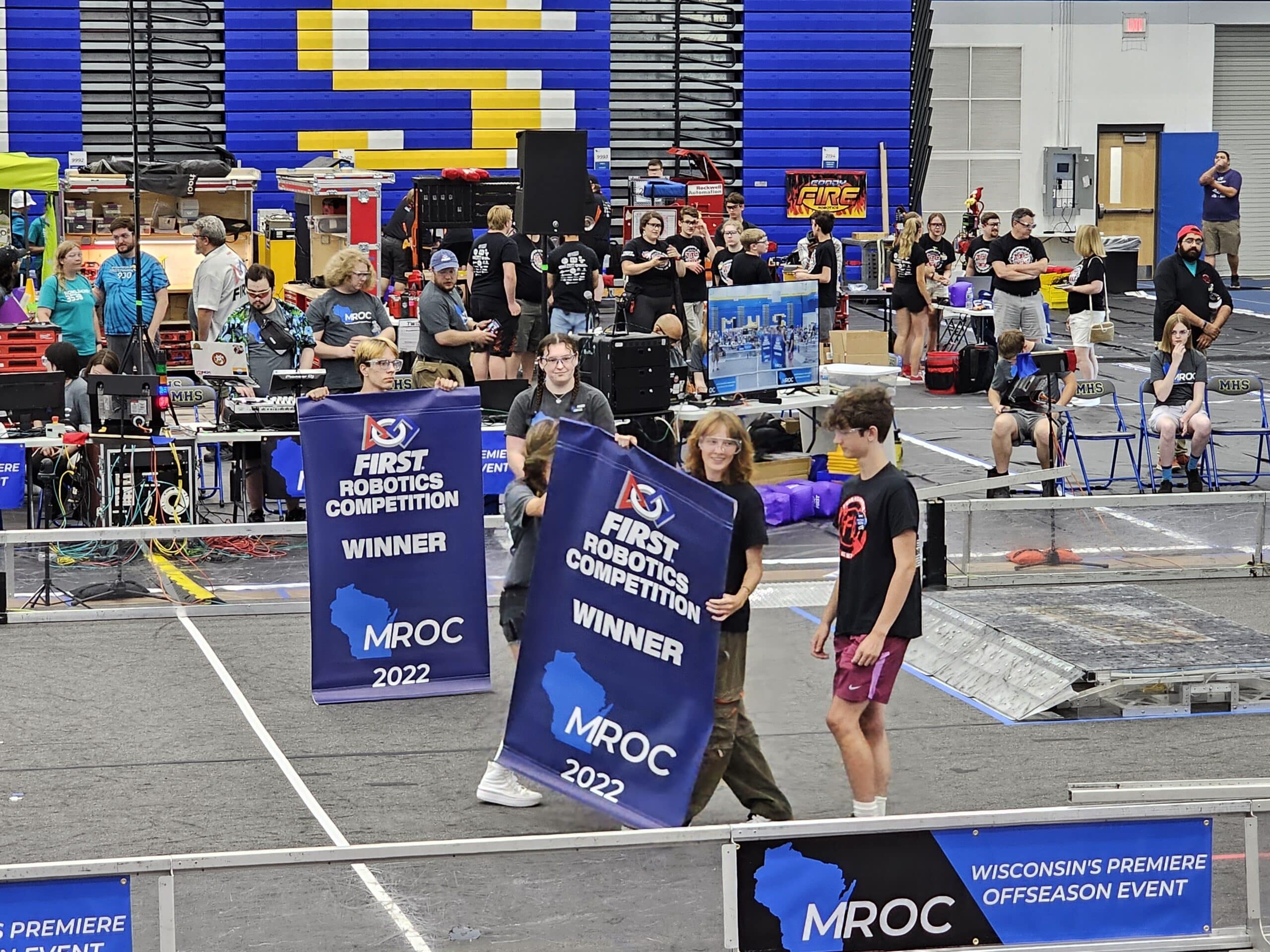 2023-2024 Team Captains Cosette Wildermuth-Breitzman and Andrew O'Toole accept a retroactive presentation of blue banners to last year's winning alliance