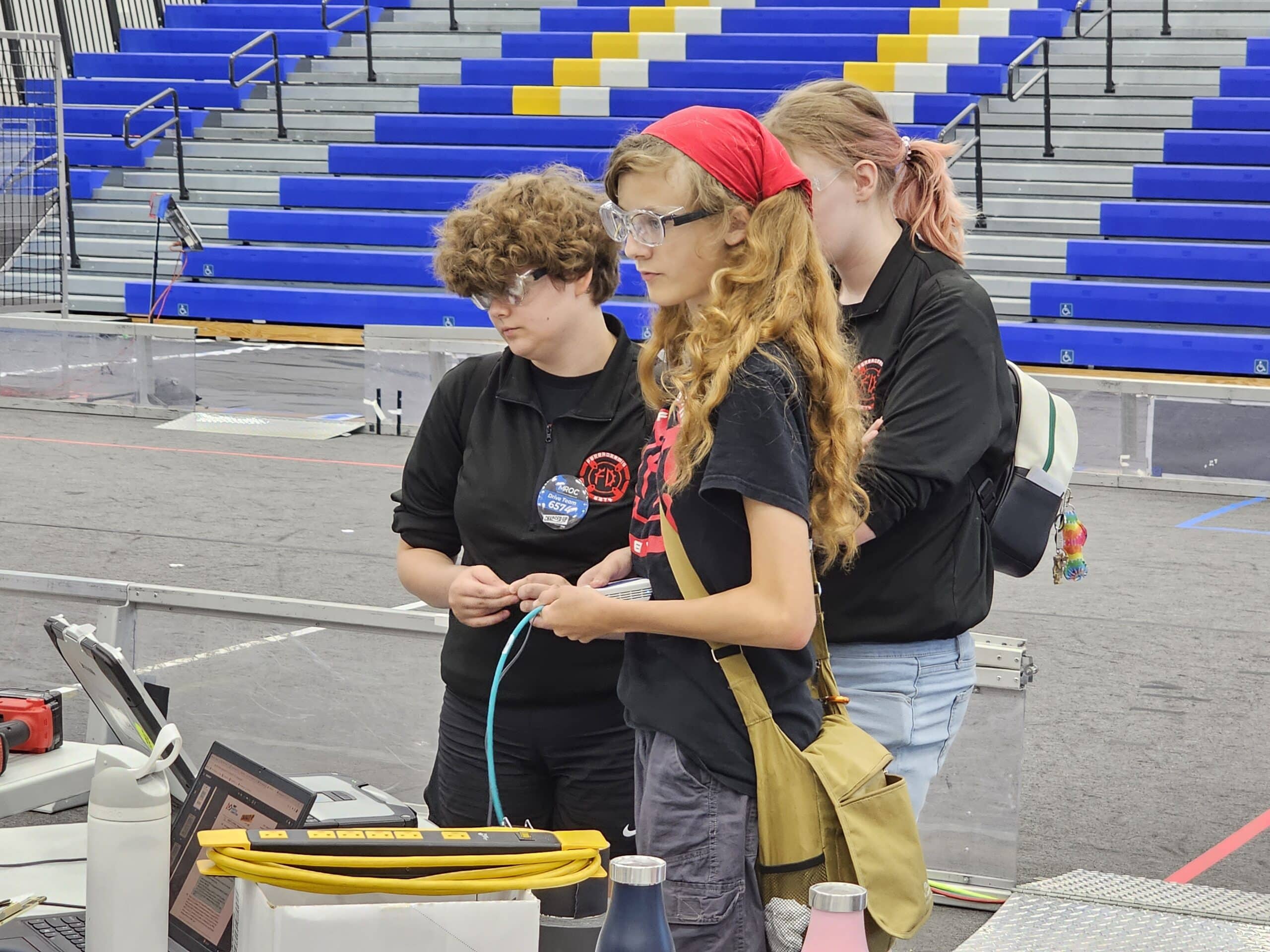 Pit Crew members take care of flashing the robot's radio to connect to the field system