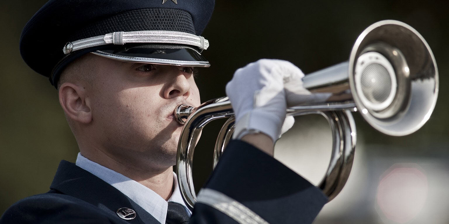 Staff Sgt. Jacob Ballard performs as the bugler during the funeral ceremony at the honor guard graduation Dec. 3 at Eglin Air Force Base, Fla. Approximately 12 new Airmen graduated from the 80-plus-hour course. The graduation performance is a full military honors funeral to include flag detail, rifle volley, pall bearers and bugler. (U.S. Air Force photo/Samuel King Jr.)